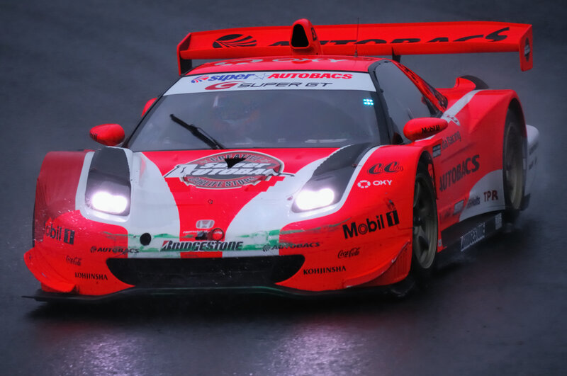 Red race car on wet track