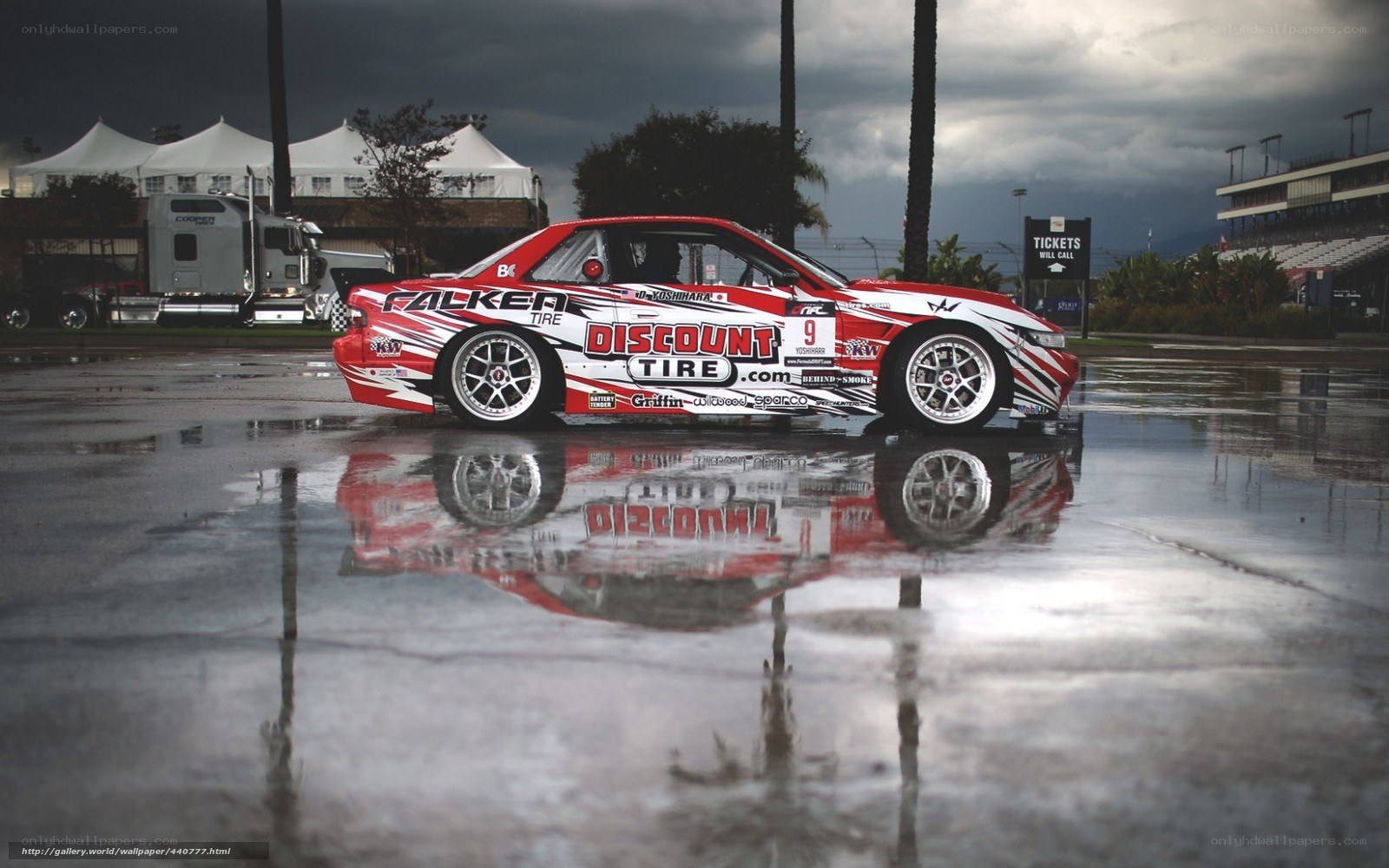 Red race car on wet track