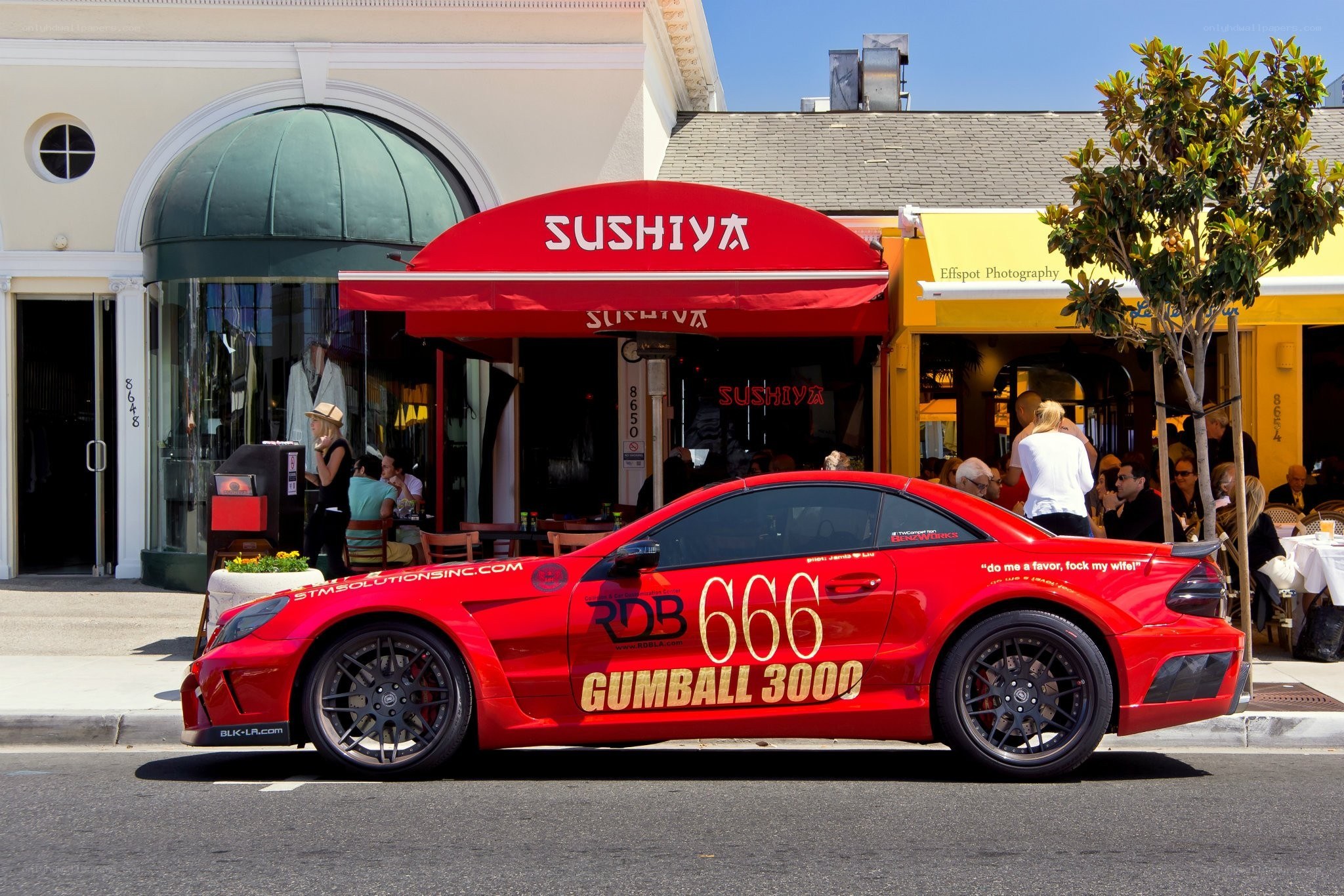 Red race car outside sushi restaurant