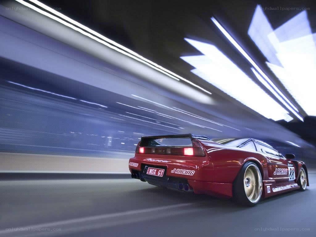 Red race car speeding at night