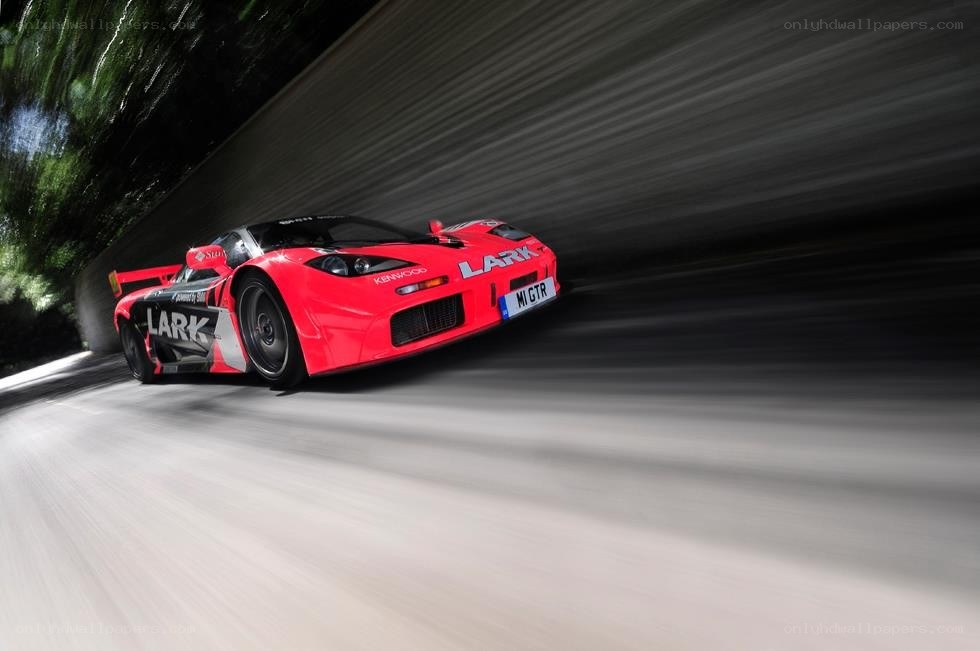 Red race car speeding on track