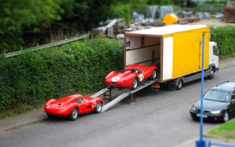 Red race cars on truck