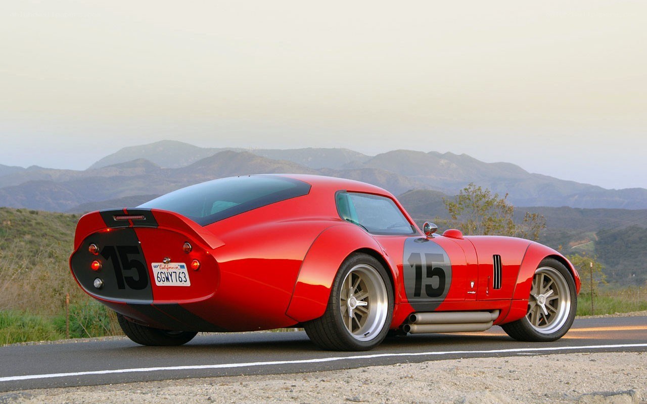 Red racing car on mountain road