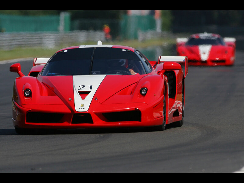 Red racing cars on a track