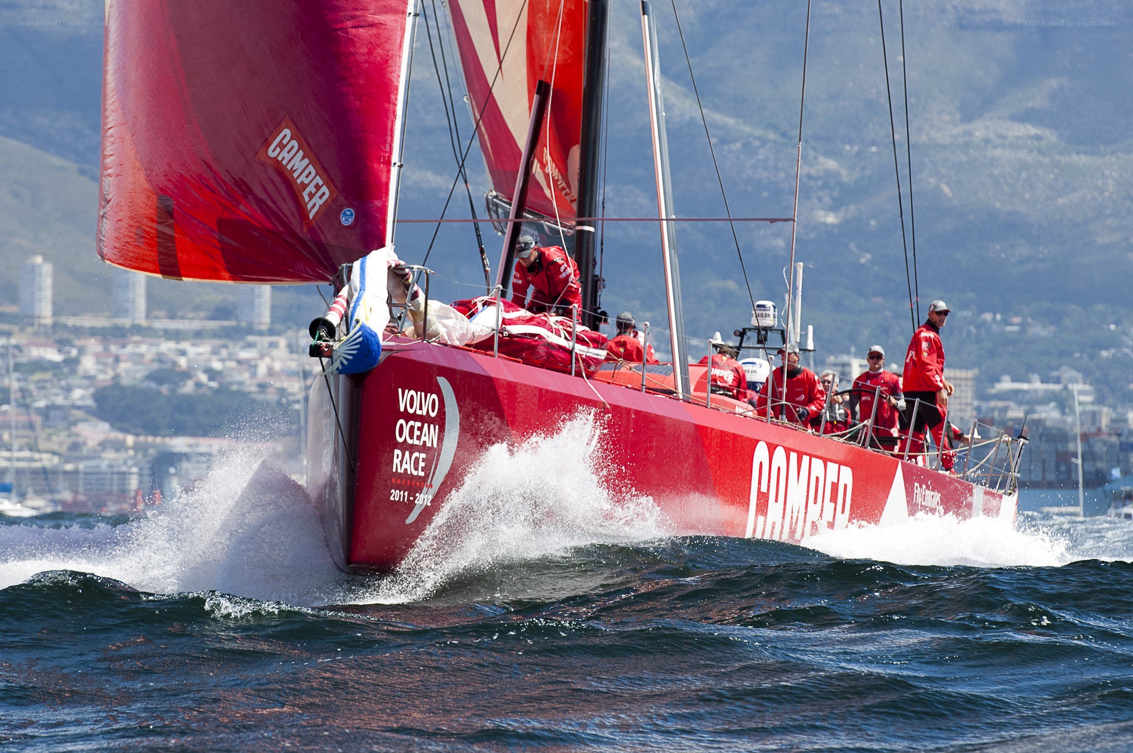 Red racing sailboat in action