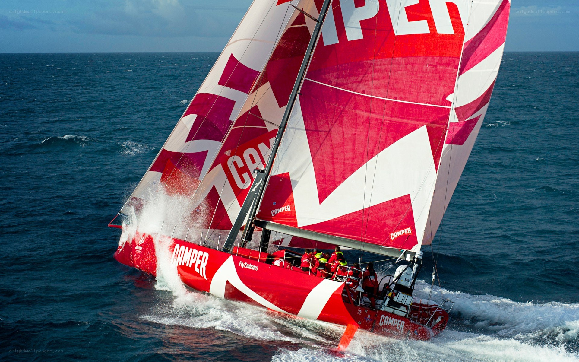 Red racing sailboat on the ocean