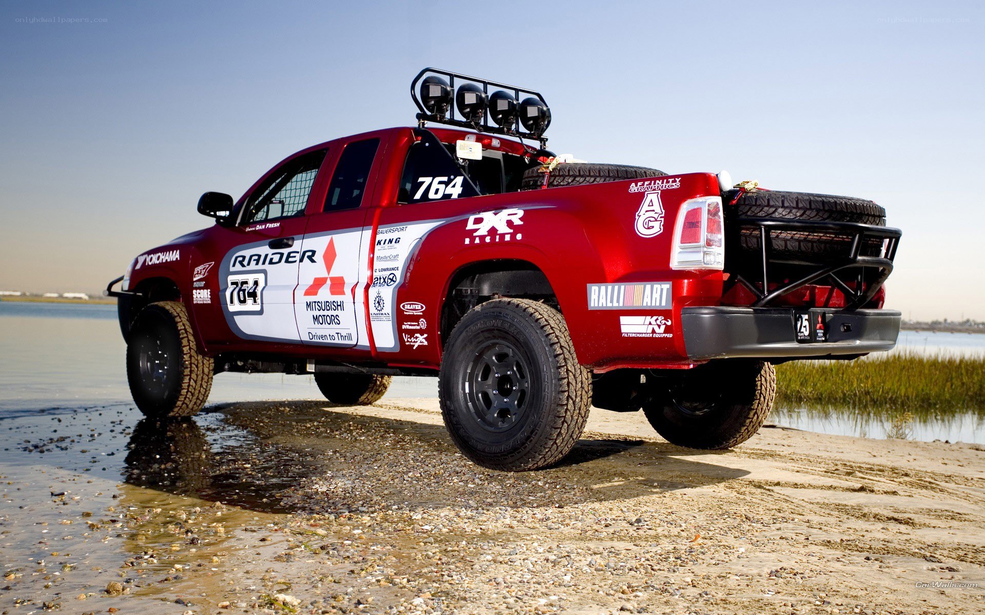 red racing truck on beach