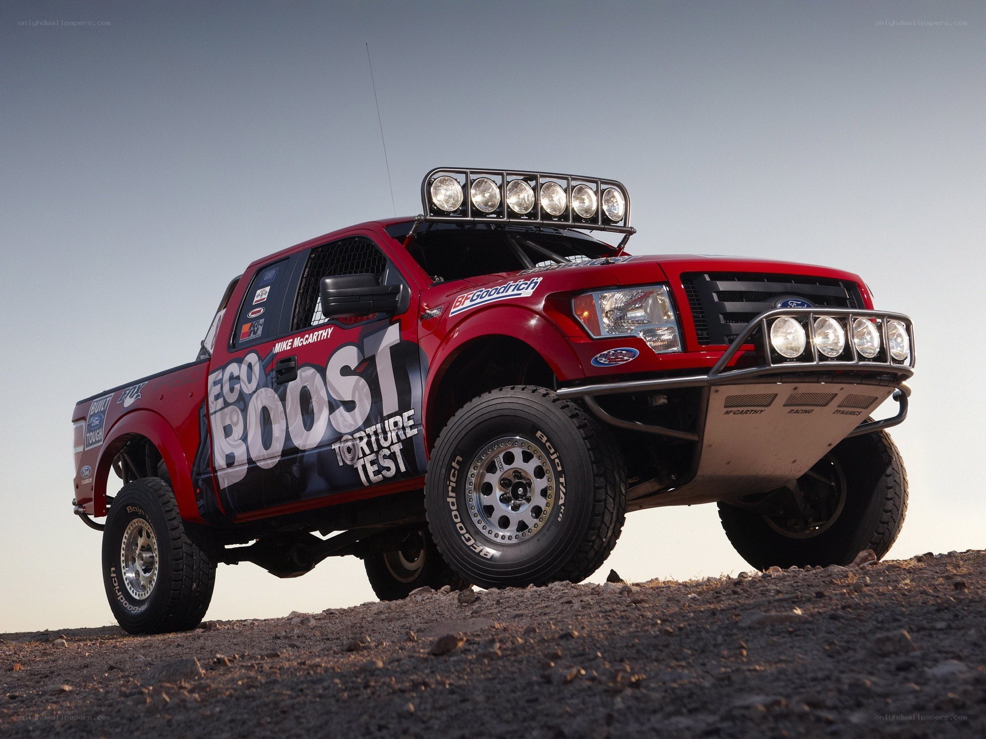 Red racing truck on dirt