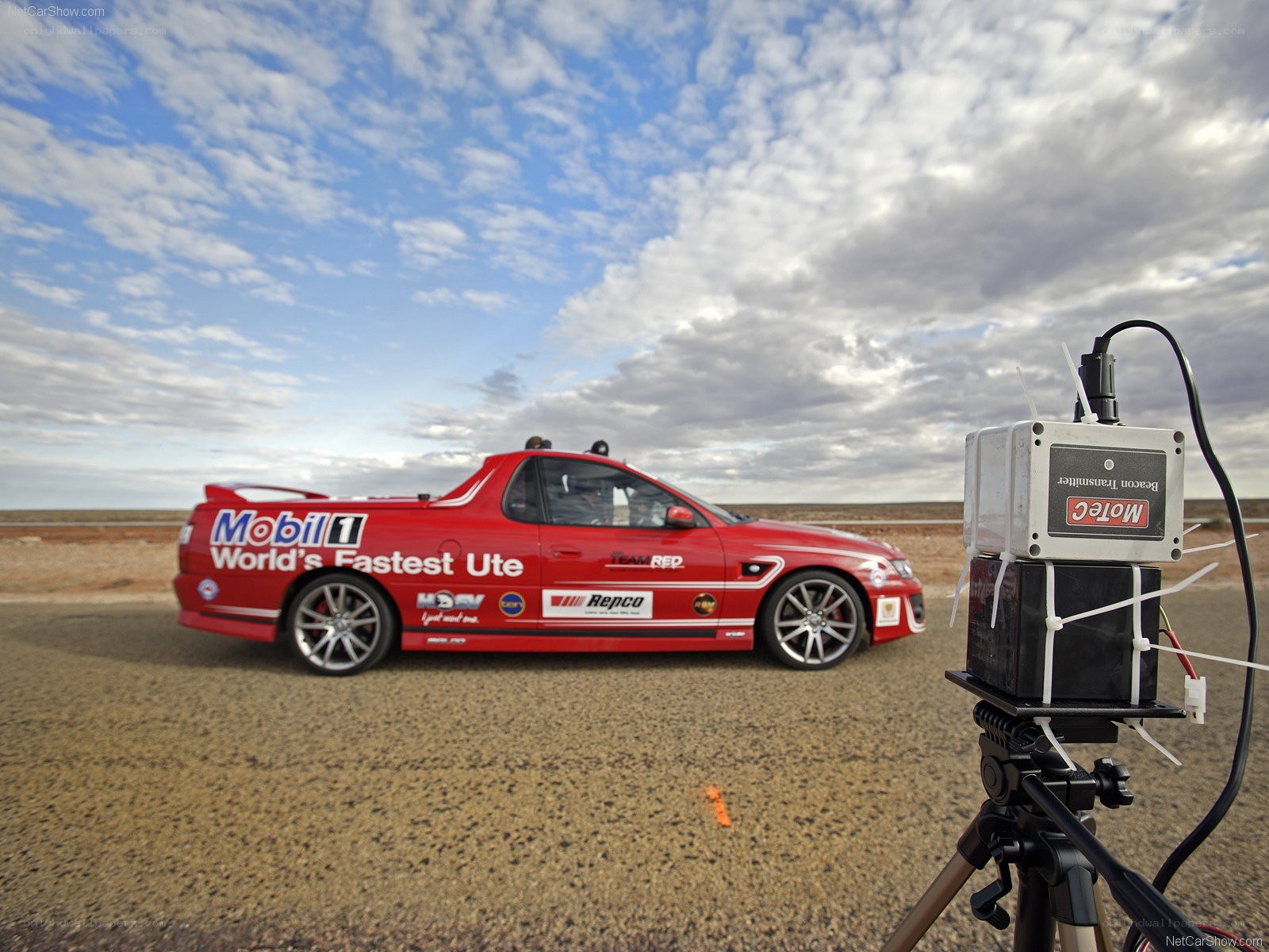 Red racing Ute on track