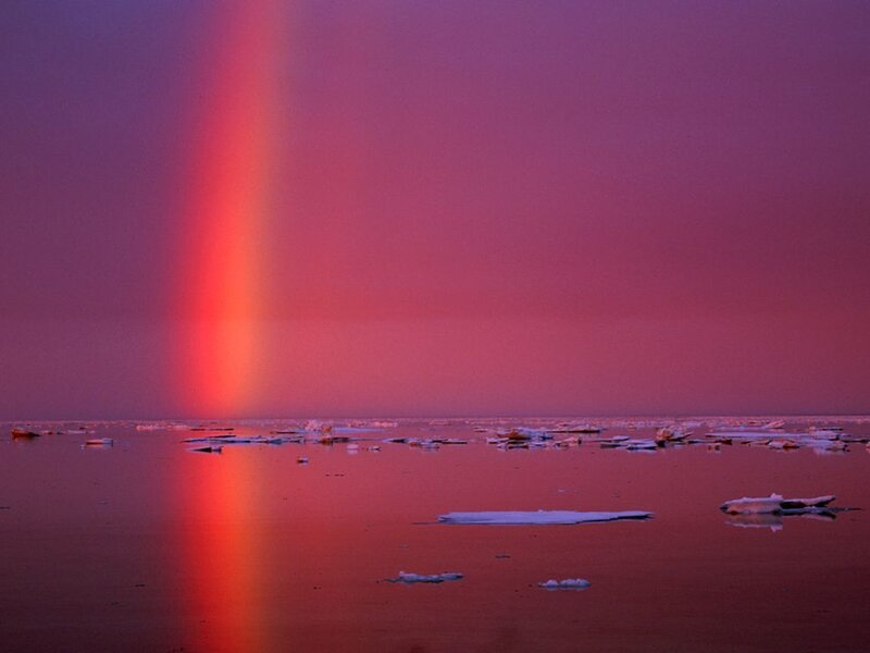 Red rainbow over icy sea