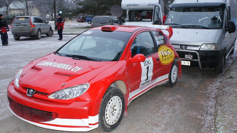 Red rally car at winter event