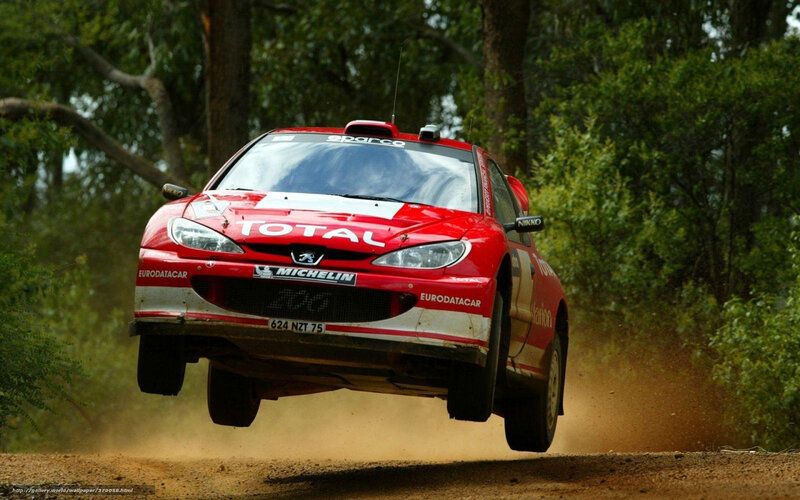 Red Rally Car in Mid-air — Dynamic, Afternoon