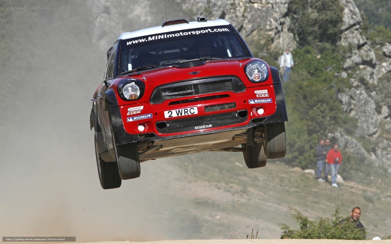 Red rally car in mid-air jump