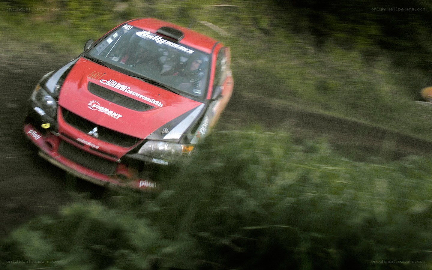 Red rally car in motion