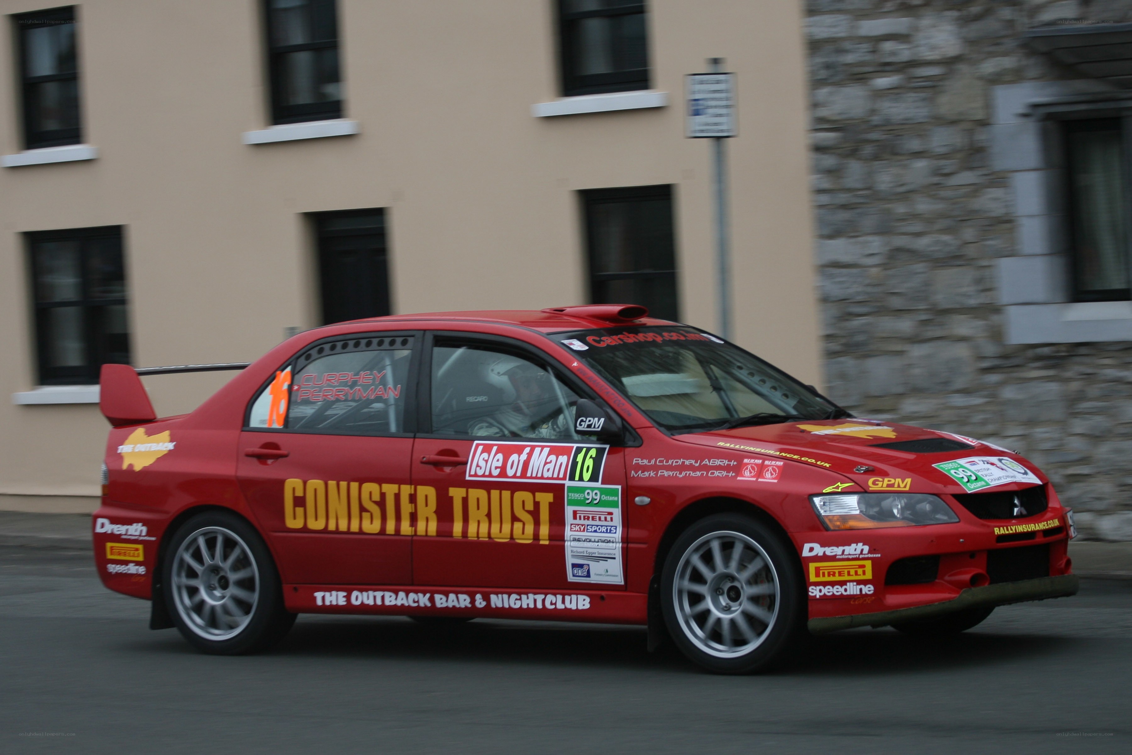 Red rally car in motion