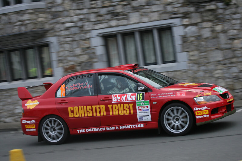 Red rally car in motion