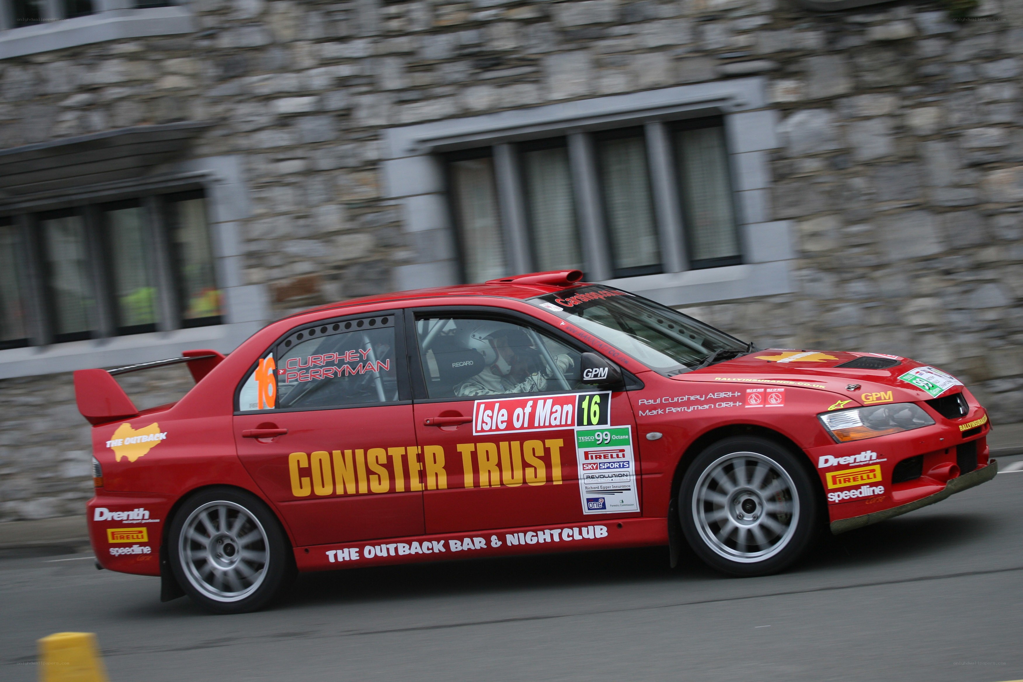Red rally car in motion