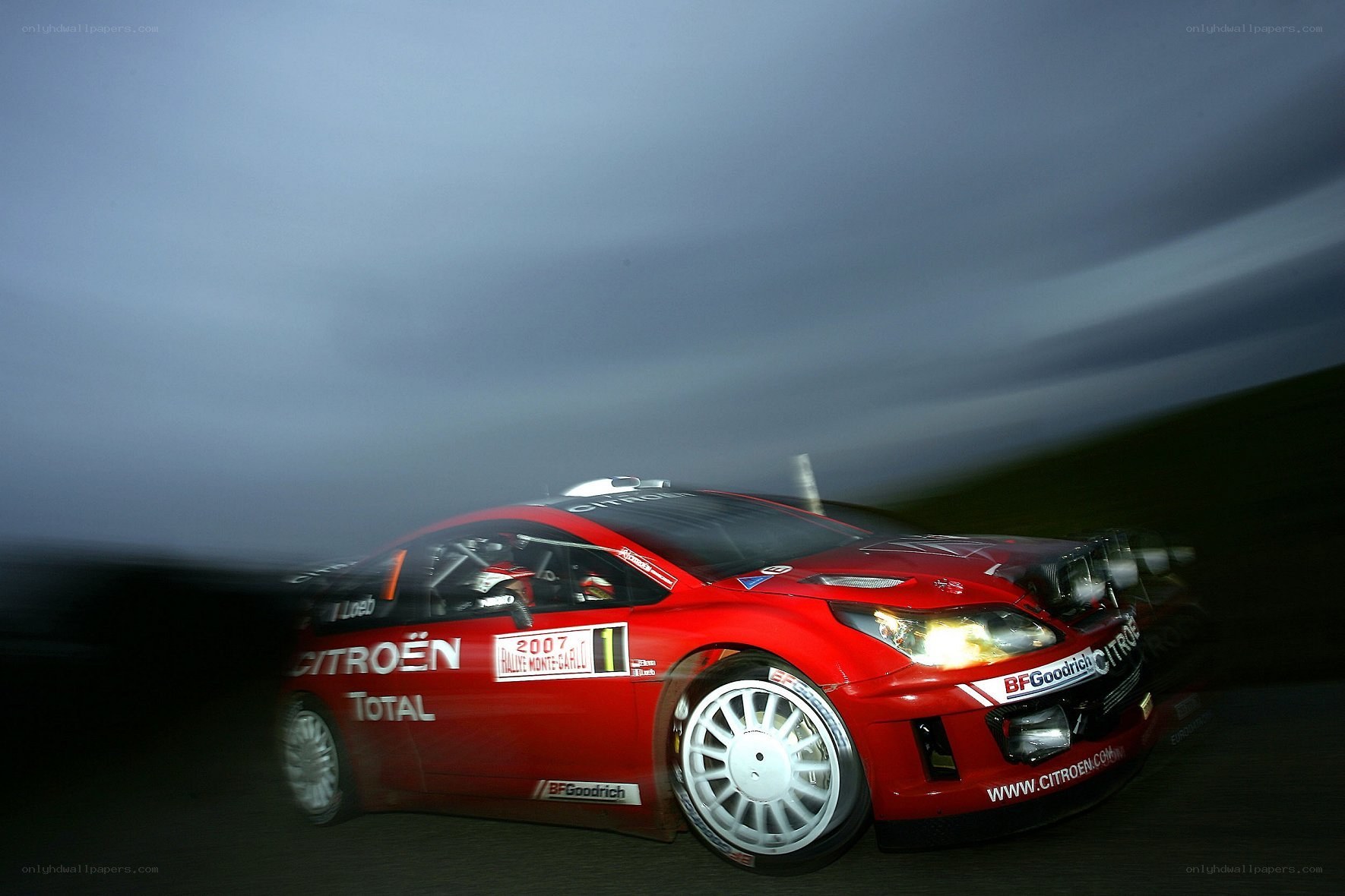 Red rally car in motion