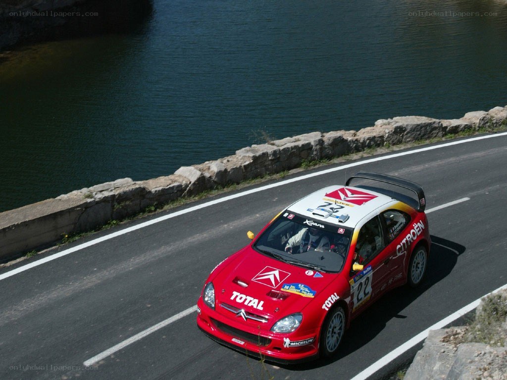 Red rally car on a road