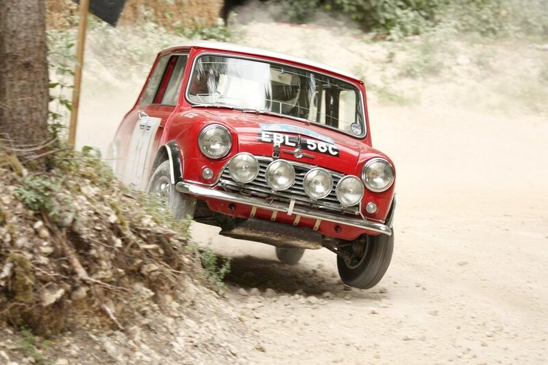 Red rally car on dirt road