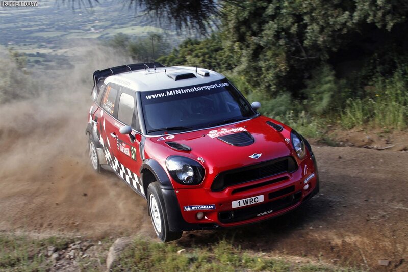 Red rally car on dirt road