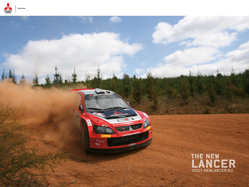 Red rally car on dirt track