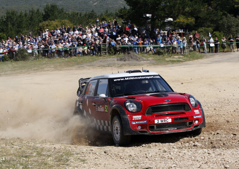 Red rally car on dirt track