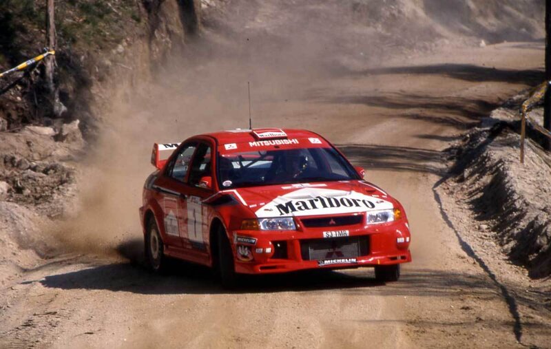 Red rally car on dirt track