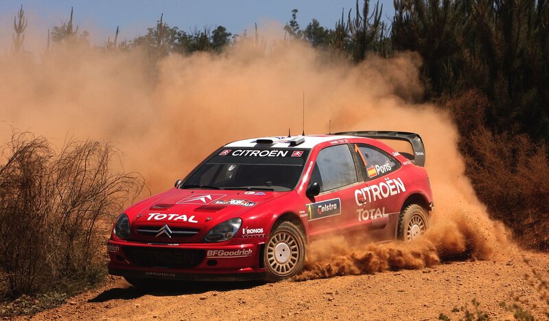 Red rally car on dirt track