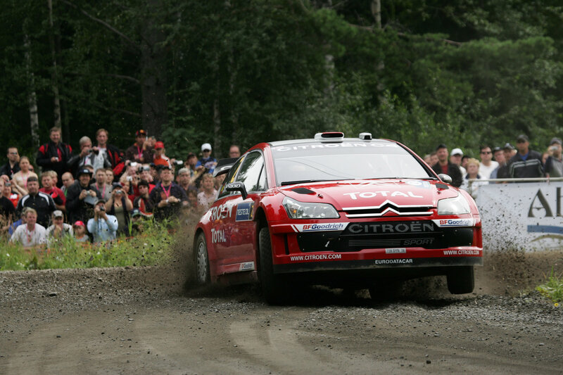 Red rally car on dirt track