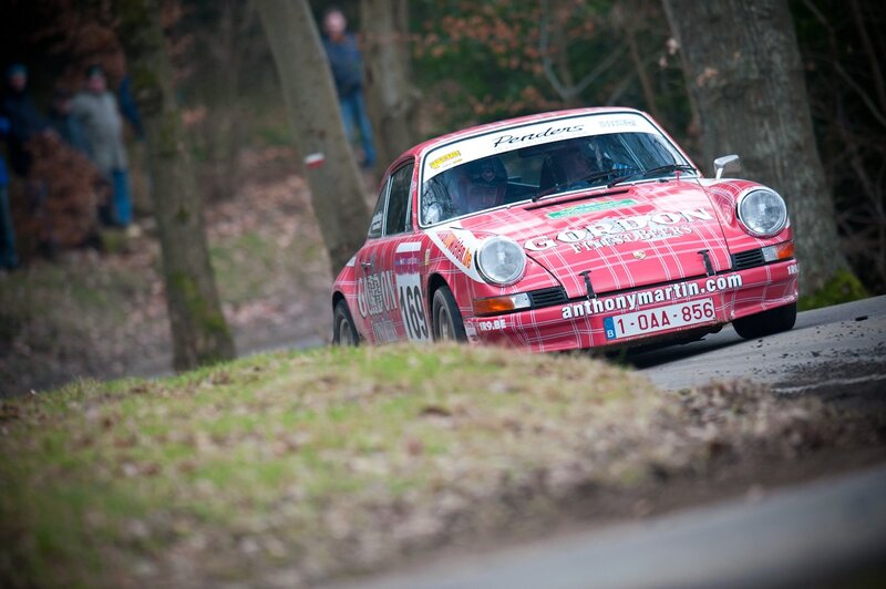 Red rally car on forest road