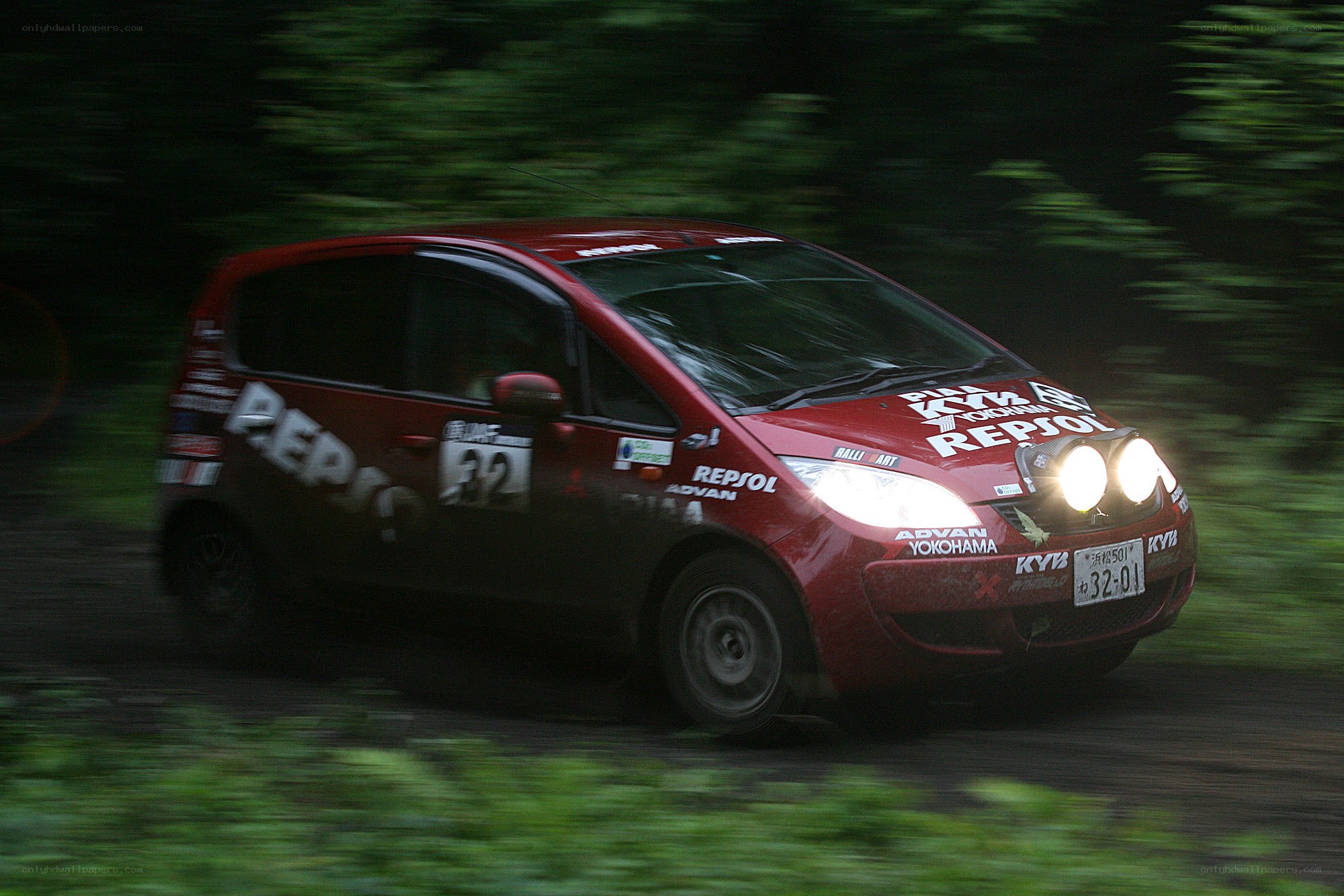 Red rally car on forest road
