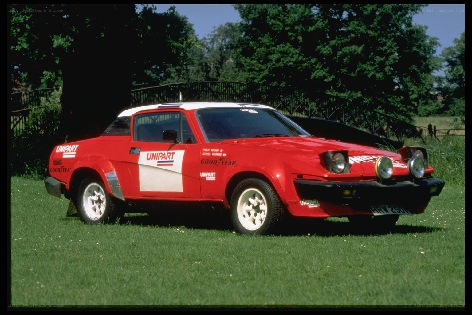 Red rally car on grass