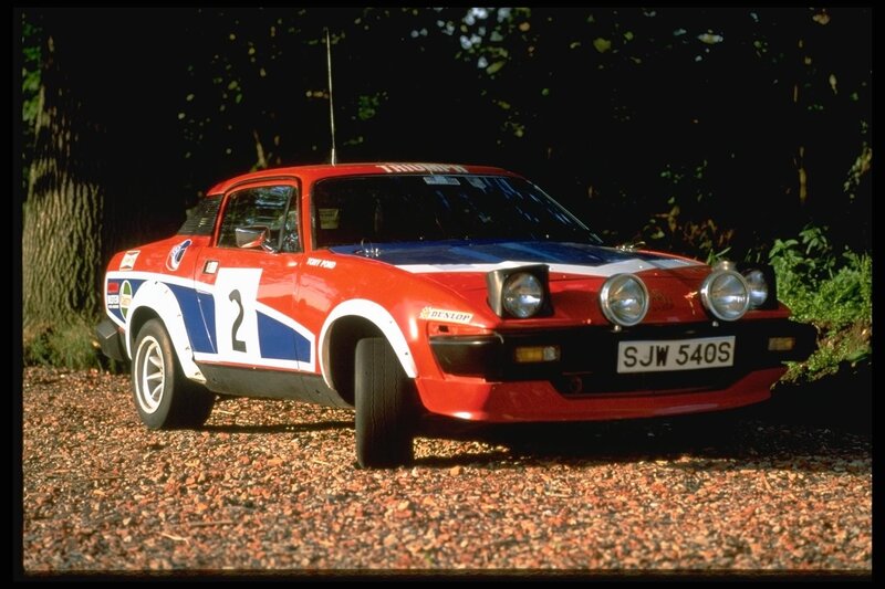 Red rally car on gravel
