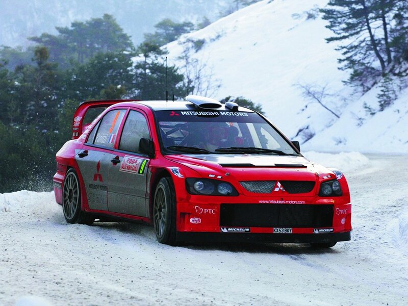 Red rally car on snowy road