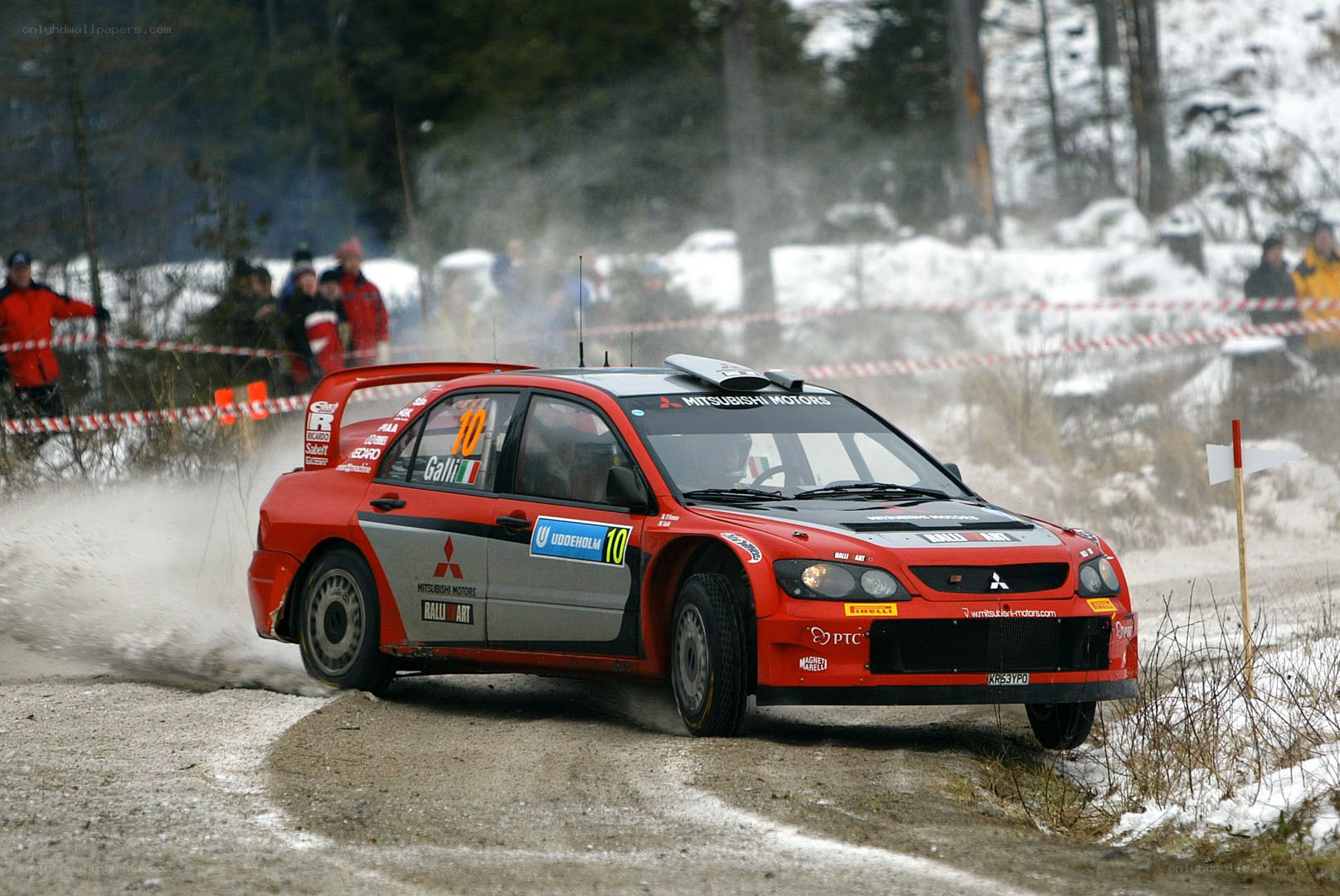 Red rally car on snowy track