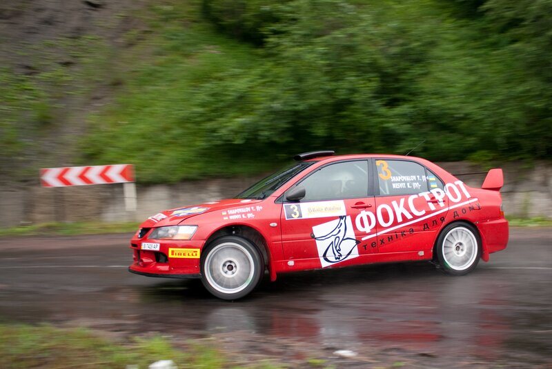 Red rally car on wet road
