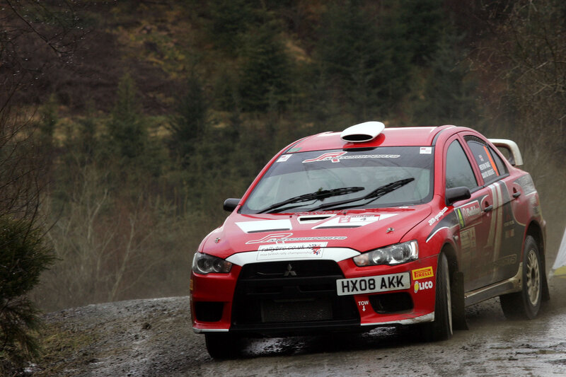 Red rally car on wet road