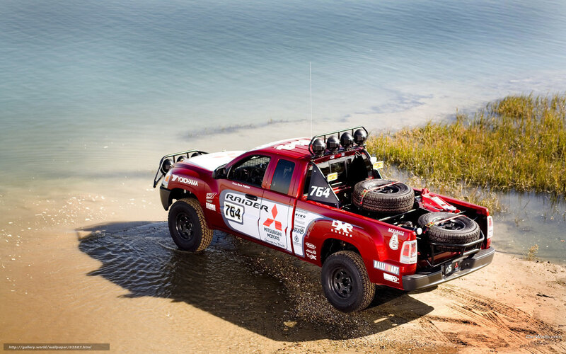 Red rally truck at the water's edge