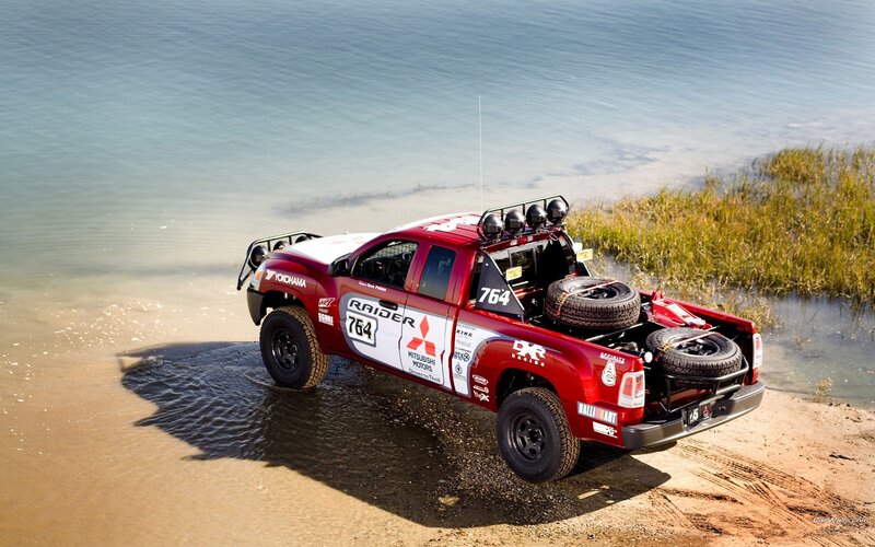 Red rally truck on beach