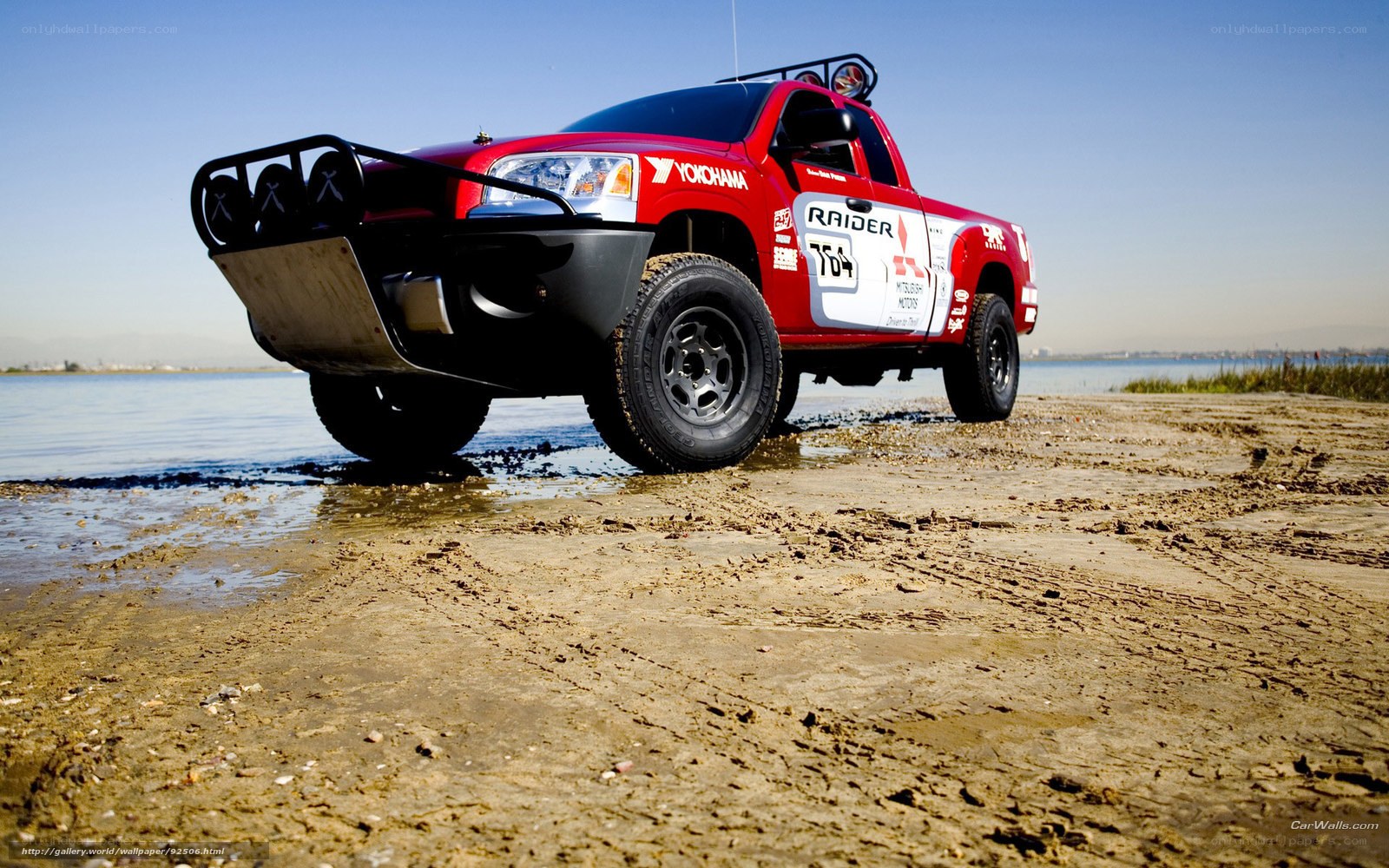 Red rally truck on beach