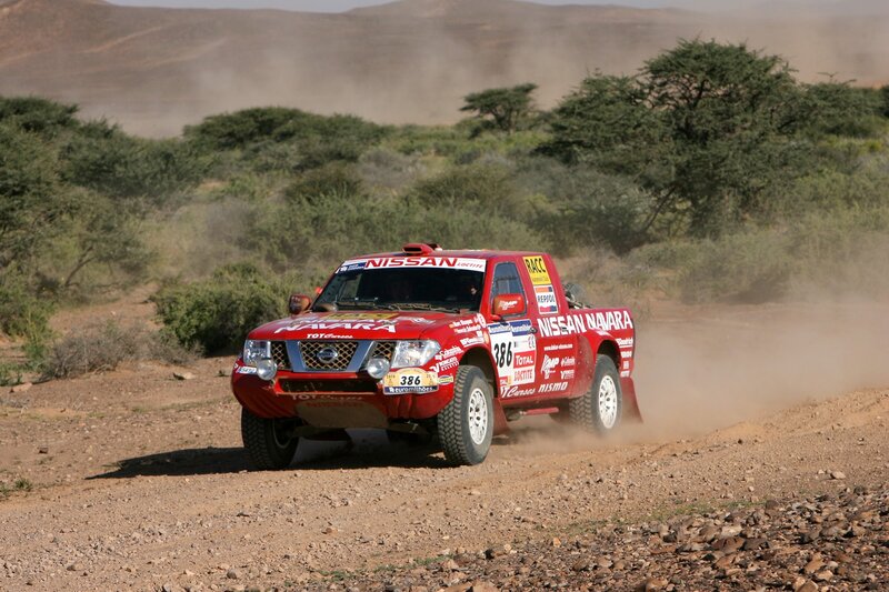 Red rally truck on dirt road