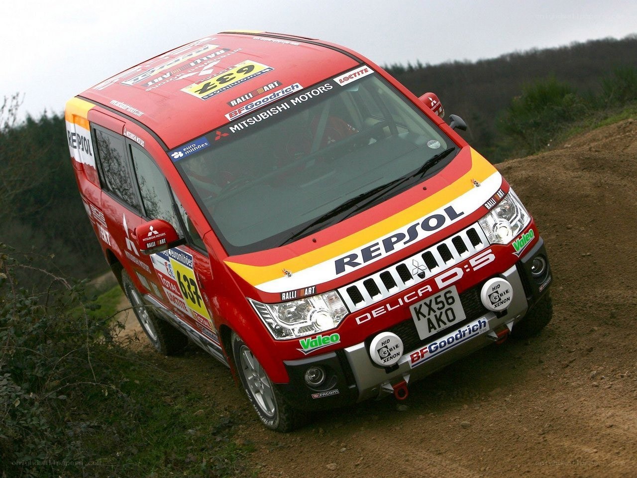 Red rally van on dirt road