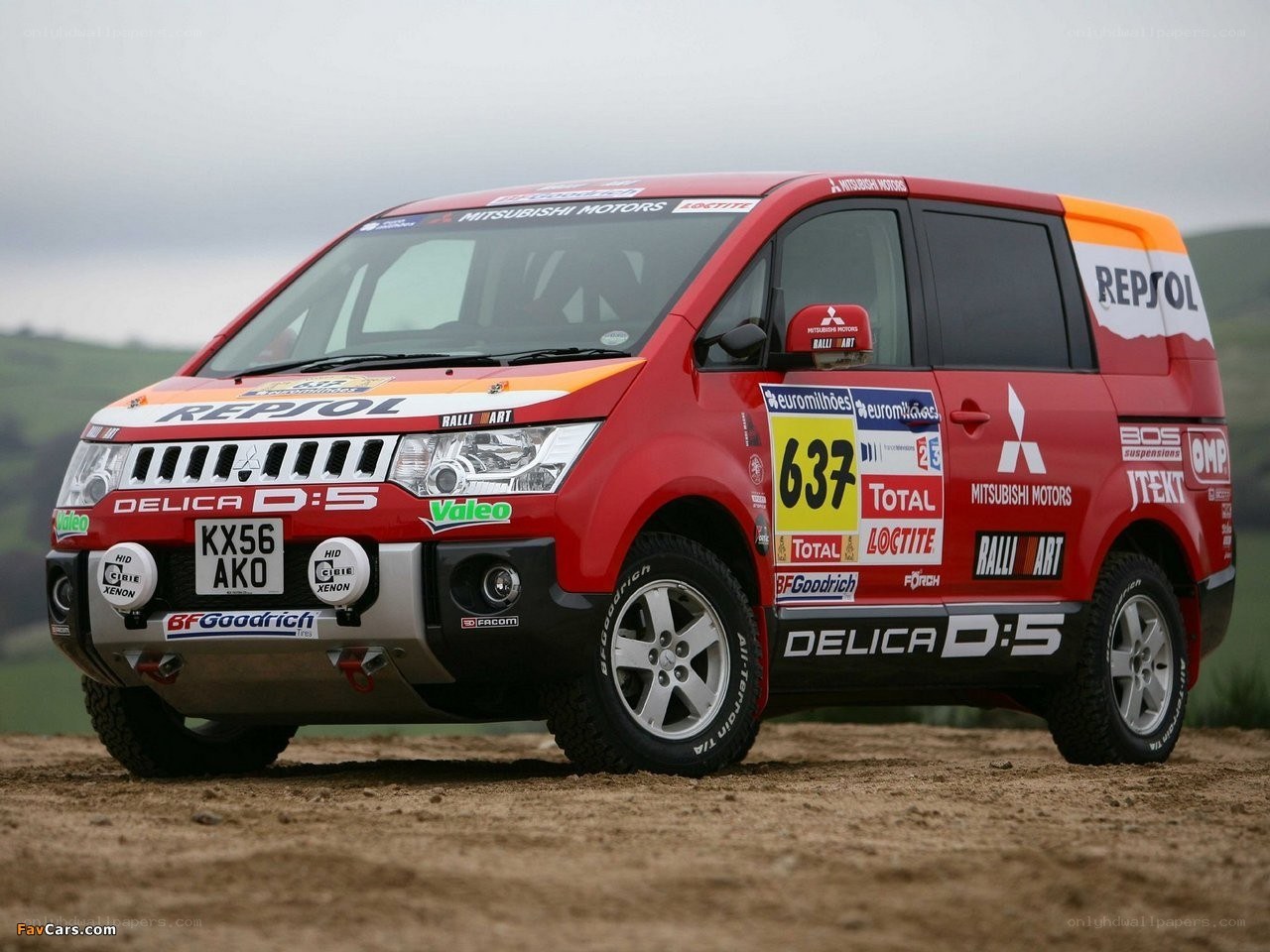 Red rally van on dirt track
