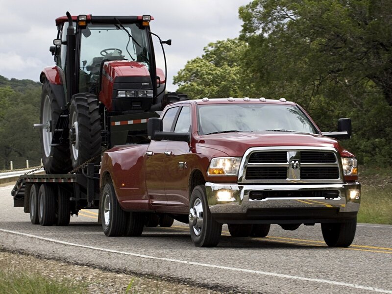 Red Ram truck towing tractor