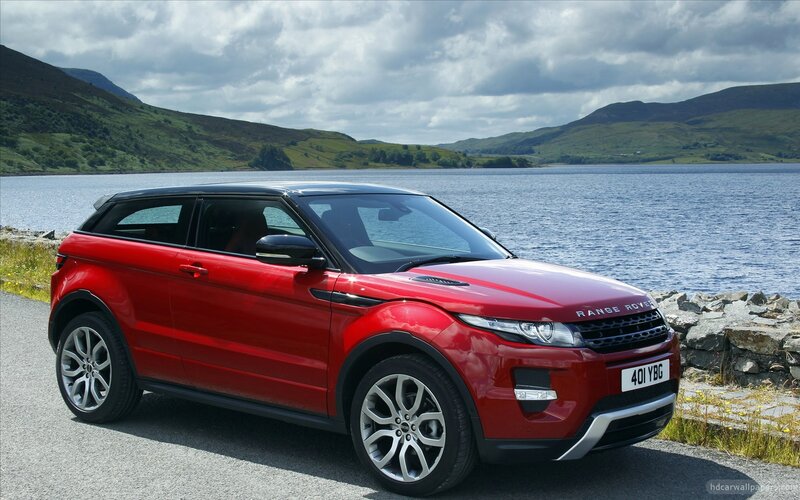 Red Range Rover by a lake