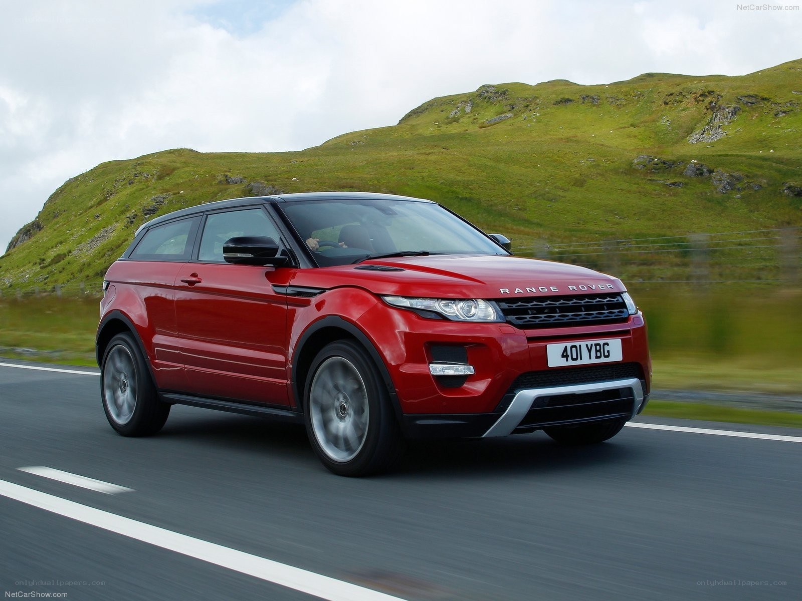 Red Range Rover driving on road