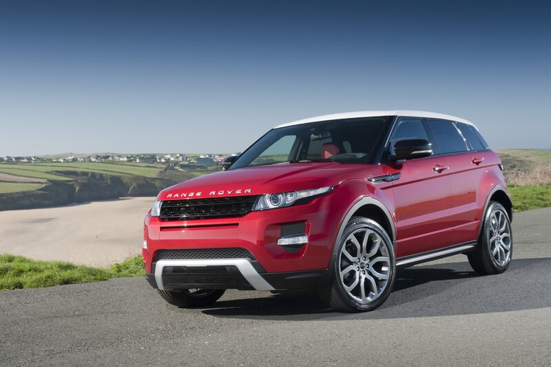 Red Range Rover Evoque on coastal road