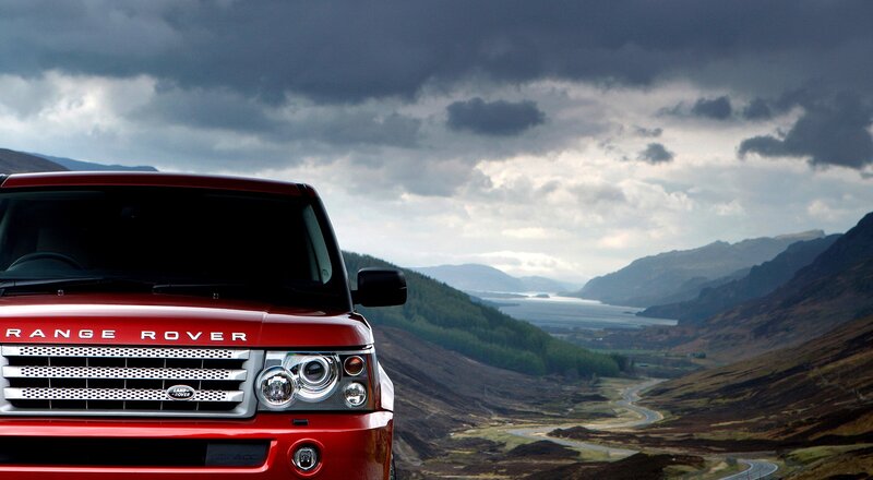 Red Range Rover in mountain landscape