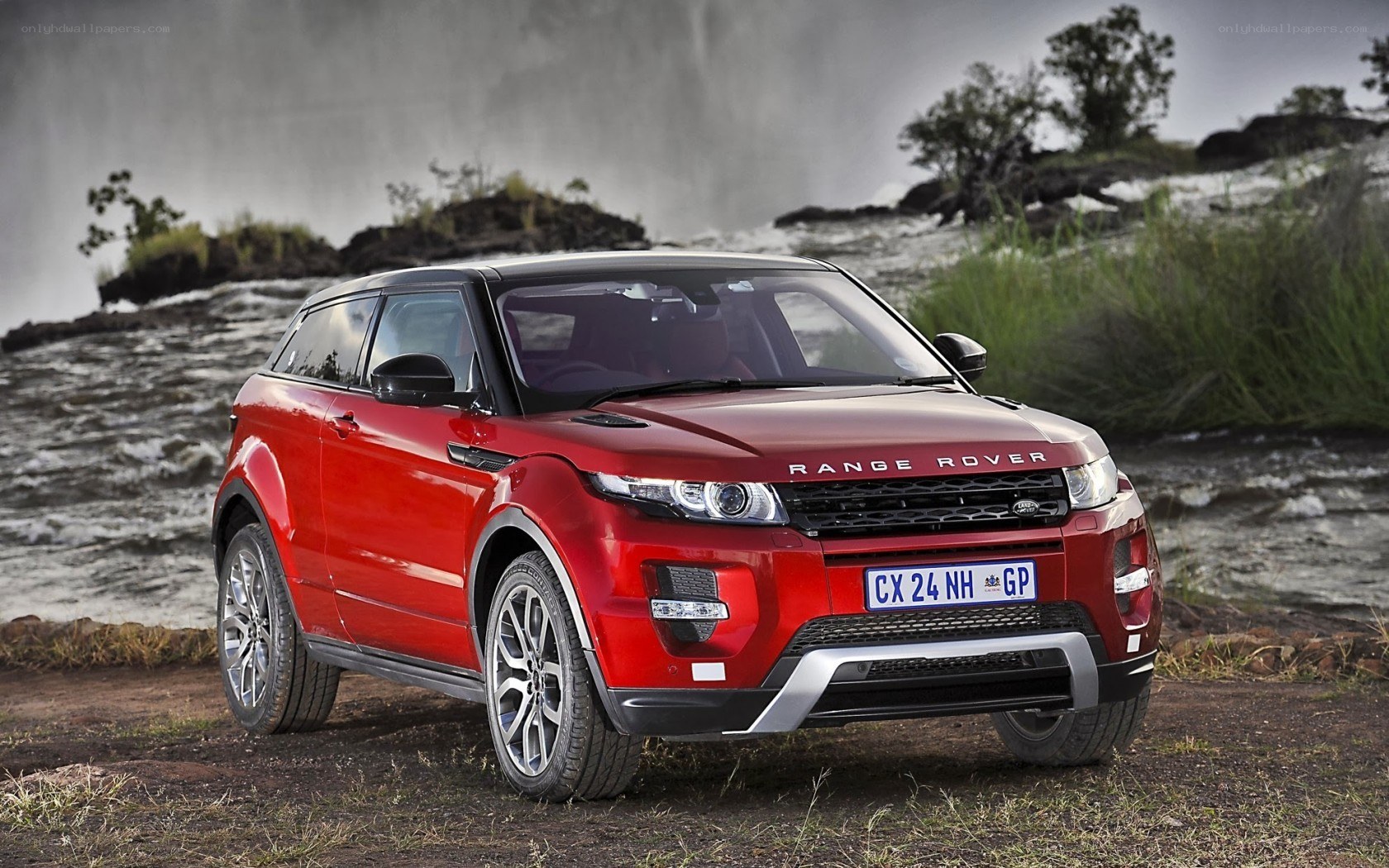 Red Range Rover in natural setting